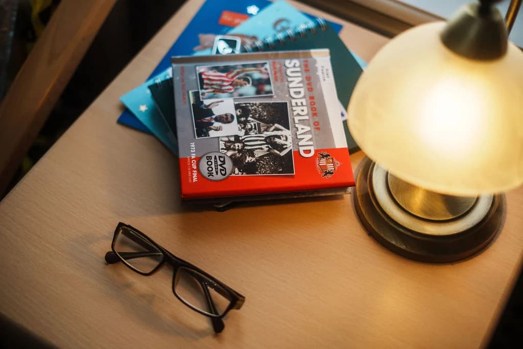 Interior - A bedside space with books and personal touches for quiet moments